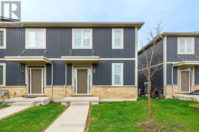 St. Catharines (Oakdale) townhouse for rent - A row of houses with the front door of the first house on the left.