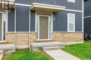 St. Catharines (Oakdale) townhouse for rent - A house with a brown door and a small porch.