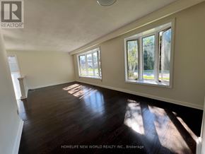 Aurora (Aurora Heights) apartment for rent - A sunny room with wooden floors and white walls.