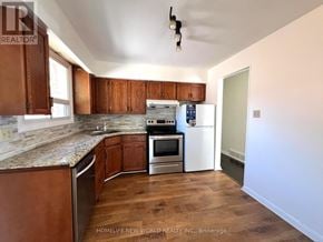 Aurora (Aurora Heights) apartment for rent - A kitchen with wooden cabinets and a white refrigerator.