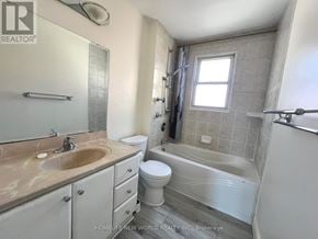 Aurora (Aurora Heights) apartment for rent - A bathroom with a sink, toilet, and bathtub.