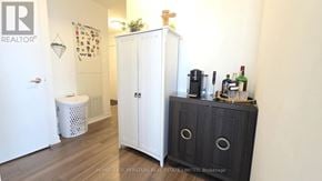 Toronto (Islington-City Centre West) condo for rent - A white cabinet with a black door is in a room with a white wall.