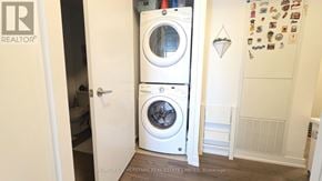 Toronto (Islington-City Centre West) condo for rent - A white washer and dryer in a small laundry room.