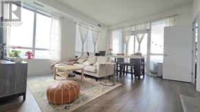 Toronto (Islington-City Centre West) condo for rent - A living room with a couch, chairs, and a rug.