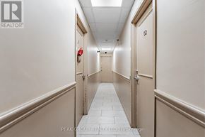Welland (Lincoln/Crowland) multi-family for rent - A hallway with beige walls and white tiled floors.