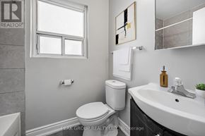 Welland (Lincoln/Crowland) multi-family for rent - A bathroom with a toilet, sink, and mirror.