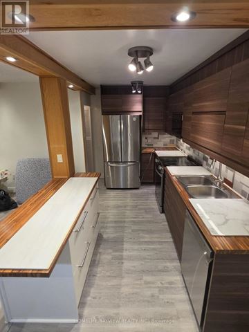Toronto (Don Valley Village) condo for rent - A kitchen with a refrigerator, stove, and sink.