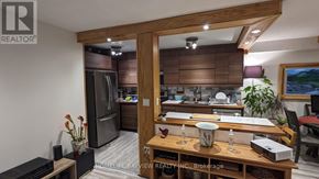 Toronto (Don Valley Village) condo for rent - A modern kitchen with a wooden table and chairs.