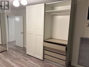 Toronto (Don Valley Village) condo for rent - A bedroom with a white door and a white wardrobe with drawers.