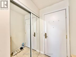Toronto (Willowdale East) condo for rent - A white door with a gold handle is in a room with white walls.