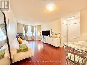 Toronto (Willowdale East) condo for rent - A living room with a white couch and a television.