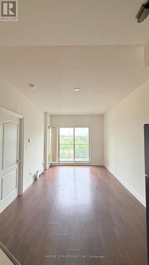 Markham (Unionville) condo for rent - A room with wooden floors and white walls.