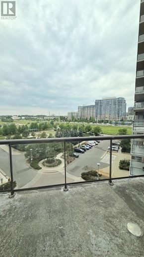 Markham (Unionville) condo for rent - A balcony overlooks a parking lot and buildings.