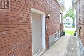 Hamilton (Crown Point) apartment for rent - A red brick wall with a white door and a sign that says REALTOR.