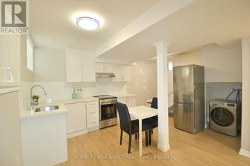 Hamilton (Crown Point) apartment for rent - A kitchen with white cabinets and a table with chairs.
