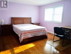 Toronto (Tam O'shanter-Sullivan) apartment for rent - A bedroom with a bed, chair, and window.