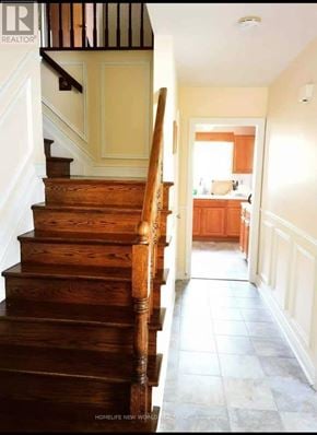 Toronto (Tam O'shanter-Sullivan) apartment for rent - A wooden staircase leads to a kitchen.