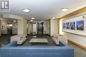 Toronto (Church-Yonge Corridor) condo for rent - A modern office lobby with a reception desk and a wall of pictures.