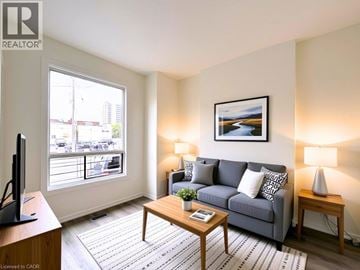 Hamilton apartment for rent - A living room with a grey couch, a wooden coffee table, and a painting on the wall.