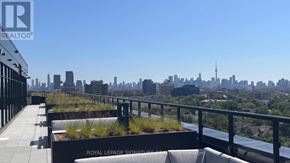 Toronto (High Park North) condo for rent - A balcony with a view of the city skyline and a sign that reads "Royal LePage Signature Realty".