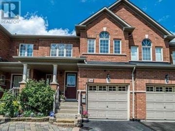 Brampton (Sandringham-Wellington) townhouse for rent - A red brick house with a garage and a front porch.