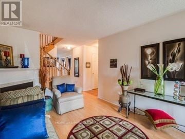 Brampton (Sandringham-Wellington) townhouse for rent - A living room with a blue rug and a white couch.