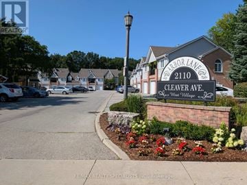 Burlington (Headon) townhouse for rent - A street view of a residential area with a sign for "Clever Ave." in front of a house.