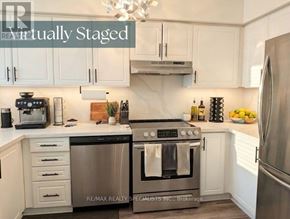 Burlington (Headon) townhouse for rent - A modern kitchen with stainless steel appliances and white cabinets.
