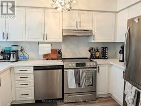 Burlington (Headon) townhouse for rent - A modern kitchen with white cabinets and stainless steel appliances.