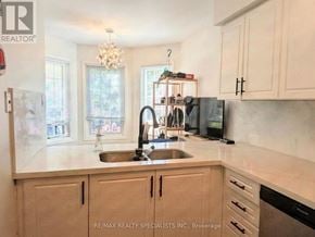 Burlington (Headon) townhouse for rent - A kitchen with a sink, stove, and cabinets.