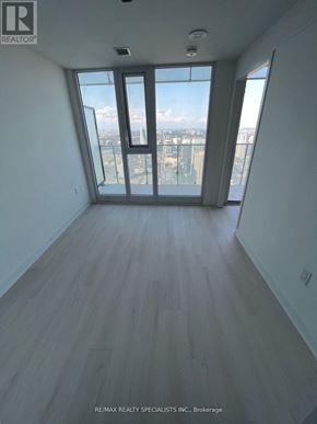 Mississauga (City Centre) condo for rent - A room with a view of the city through a large window.
