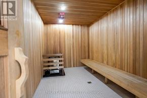 Toronto (Banbury-Don Mills) condo for rent - A wooden sauna room with benches and a light on the ceiling.