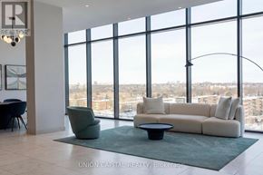 Toronto (Banbury-Don Mills) condo for rent - A living room with a couch, chair, and large windows overlooking a cityscape.