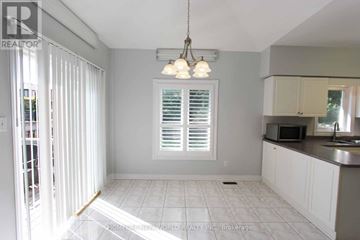 Newmarket (Gorham-College Manor) apartment for rent - A kitchen with white cabinets and a tiled floor.
