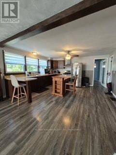 Fort Erie (Ridgeway) apartment for rent - A well-lit kitchen with wooden floors and furniture.
