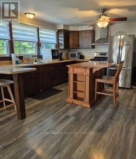 Fort Erie (Ridgeway) apartment for rent - A kitchen with wooden floors and a refrigerator.