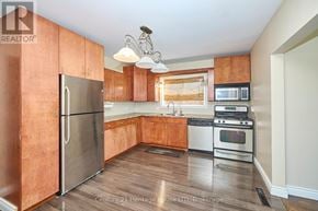 Fort Erie (Central) apartment for rent - A kitchen with wooden cabinets and stainless steel appliances.