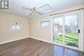 Fort Erie (Central) apartment for rent - A room with a ceiling fan and a sliding glass door.