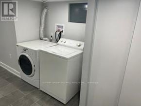Toronto (New Toronto) apartment for rent - A white washer and dryer in a laundry room.
