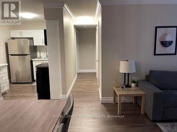 London North (North G) condo for rent - A living room with a grey couch and a wooden coffee table.