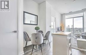 Toronto (Yonge-St. Clair) condo for rent - A modern dining room with a table set for four.