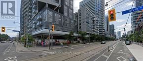 Toronto (Regent Park) condo for rent - A street view of a city with a building that has a sign that says REALTOR on it.