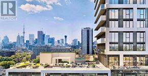 Toronto (Regent Park) condo for rent - A modern building with a balcony overlooks a city skyline.
