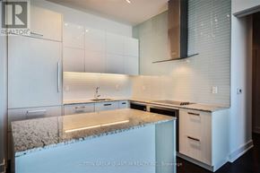 Toronto (Lawrence Park South) condo for rent - A kitchen with white cabinets and a granite countertop.