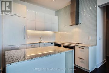 Toronto (Lawrence Park South) condo for rent - A kitchen with white cabinets and a granite countertop.
