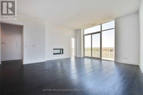 Toronto (Lawrence Park South) condo for rent - A large, empty room with a view of the outside through large windows.