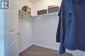 Whitby apartment for rent - A white closet with a coat hanging on a rod.