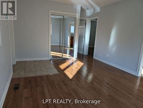 Toronto (West Hill) apartment for rent - A room with wooden flooring and a sliding glass door.