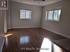Toronto (West Hill) apartment for rent - A room with wooden flooring and two windows.