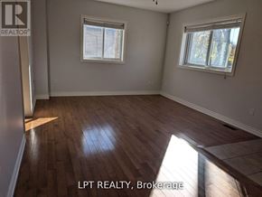 Toronto (West Hill) apartment for rent - A room with wooden flooring and two windows.